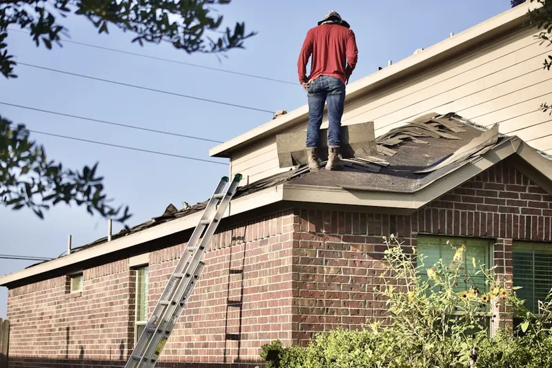 Professional roofer working on a residential roof in Lake Hallie